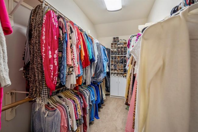 Inside the spacious primary closet, you'll find plenty of hanging space, offering ample room for organization and storage. | Image 22