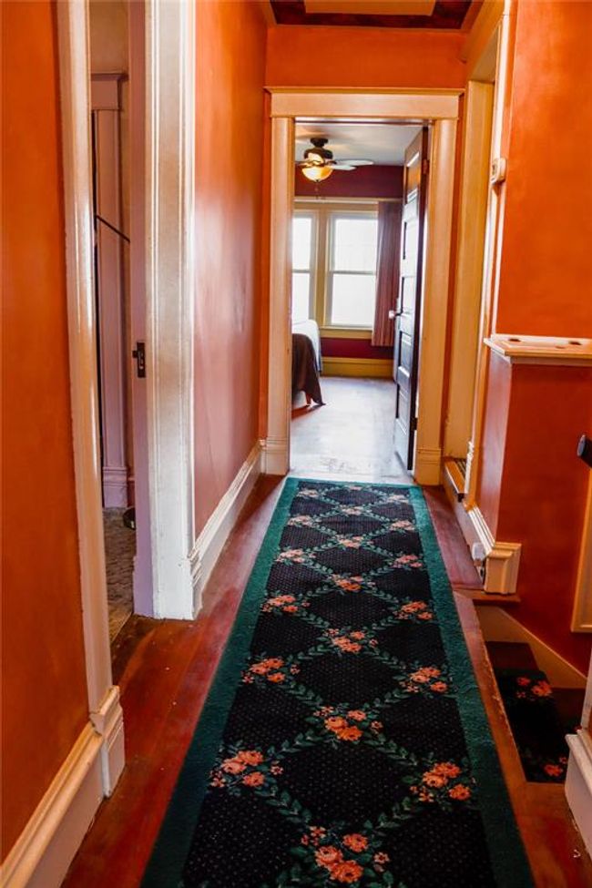 The second floor Hall features a customized area rug, and two more bedrooms down this hallway | Image 29