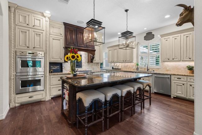 The oversized eat-in island completes the room. Just around the corner is a built-in desk area, perfect for paying bills and storing keys... | Image 19