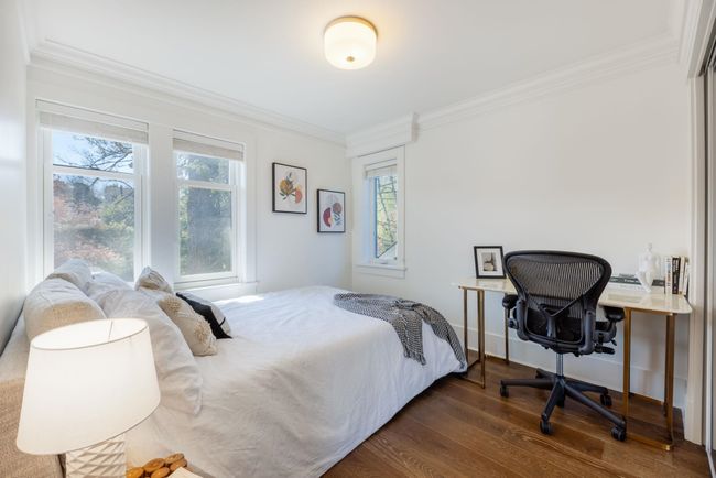 Bedroom with dark wood finished floors and crown molding | Image 16