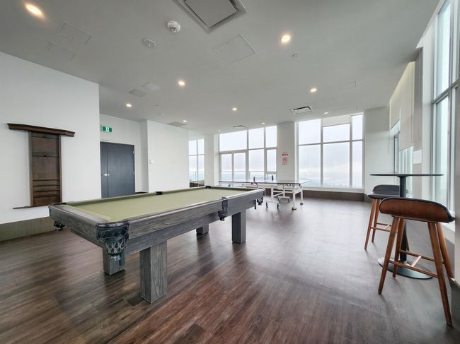 Rec room featuring wood finished floors, recessed lighting, billiards, and a wall of windows | Image 12