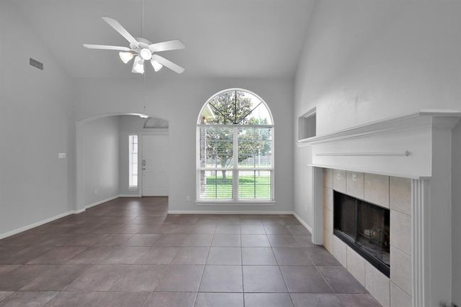 The elegant arched window and vaulted ceilings provide abundant light into your living area. | Image 7