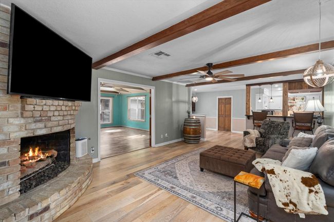 Another photo of the cozy living room opening up into the game/ flex room. | Image 17