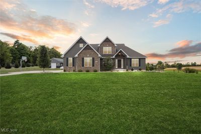 Craftsman-style home featuring a garage and a yard | Image 1