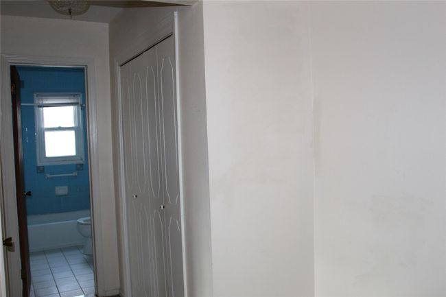 Hallway to bath and bedroom & includes double coat closet & separate linen closet. | Image 13