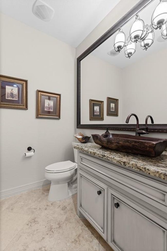 There are two different half baths downstairs in the home. This is the first one. It's oversized and shows up a gorgeous wooden bowl sink... | Image 17