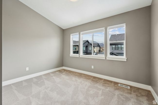 Empty room featuring lofted ceiling, visible vents, baseboards, and light carpet | Image 37