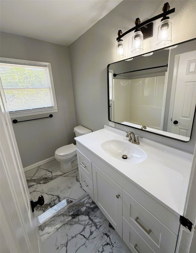 Bathroom with toilet, vanity, marble floor | Image 17