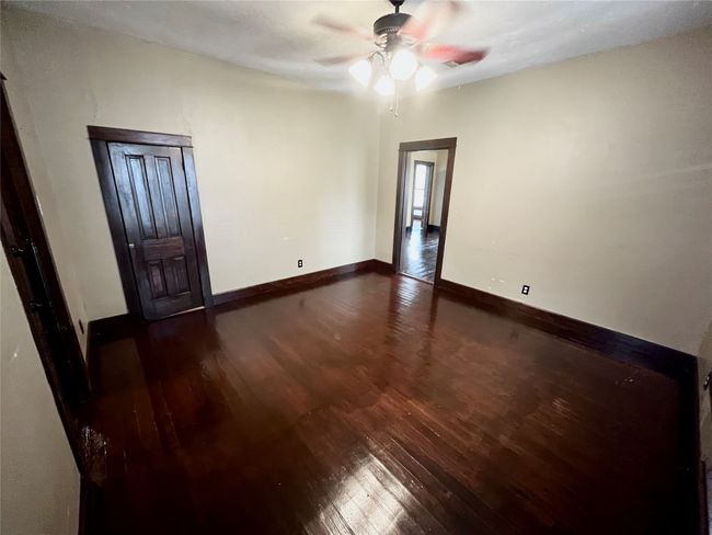 wood floors and a ceiling fan, storage closet under the stairs | Image 13