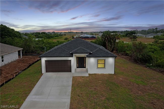 View of front of home with a garage and a yard | Image 6