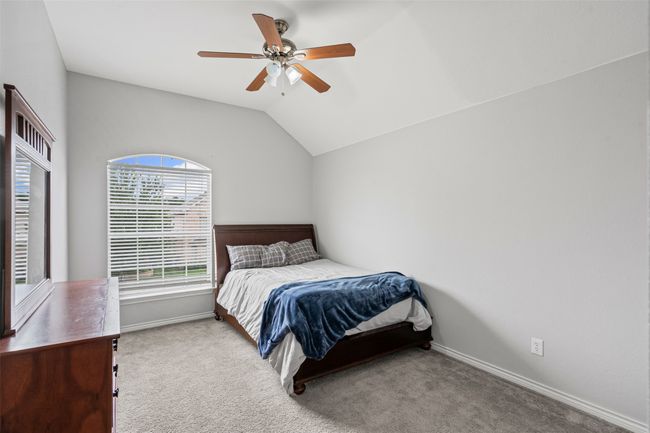 Carpeted bedroom featuring lofted ceiling and a ceiling fan | Image 28