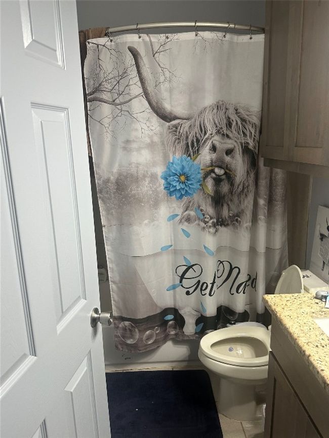 Bathroom featuring vanity, toilet, and a shower with shower curtain | Image 36