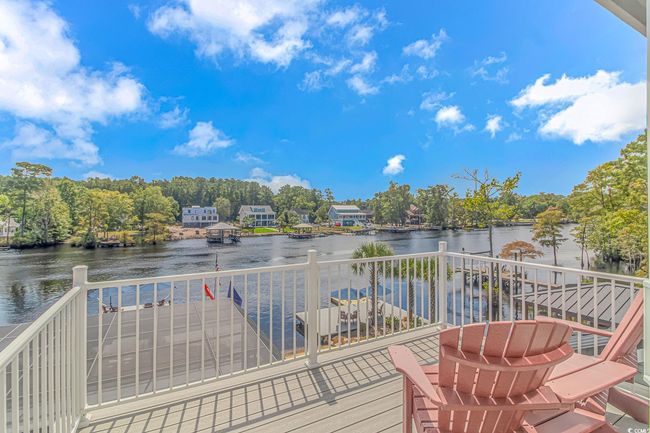Wooden deck featuring a water view and view of wooded area | Image 33