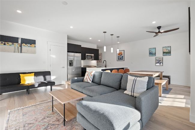 Living room featuring ceiling fan, sink, and light hardwood / wood-style flooring | Image 11