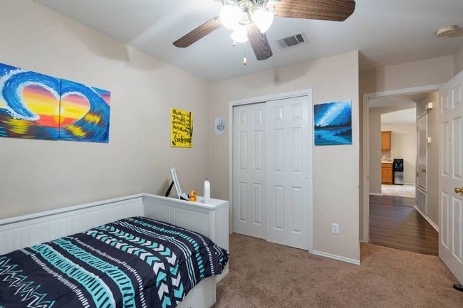 Carpeted bedroom with a closet and ceiling fan | Image 20