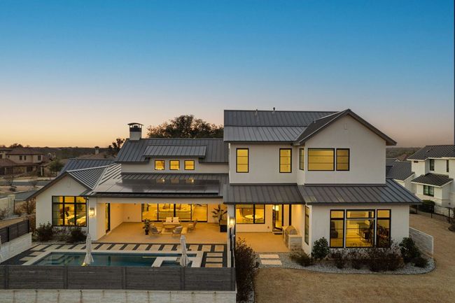 Back of house with fence private yard, a standing seam roof, metal roof, and stucco siding | Image 35