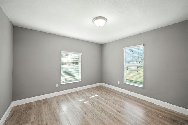 Unfurnished room with wood finished floors and baseboards | Image 12