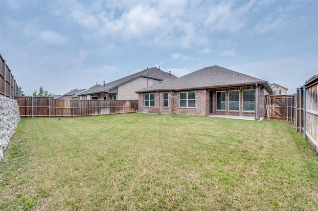Rear view of house with brick siding and roof with shingles | Image 24