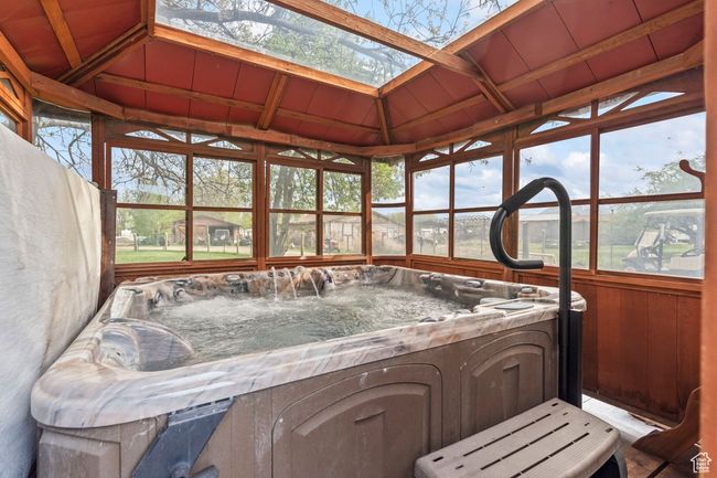 Sunroom / solarium featuring a skylight and a jacuzzi | Image 26