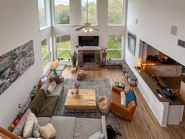 Living room with a high ceiling, healthy amount of natural light, and wood finished floors | Image 15