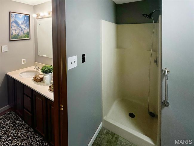 Bathroom featuring a walk in shower, double vanity, and tile patterned floors | Image 10
