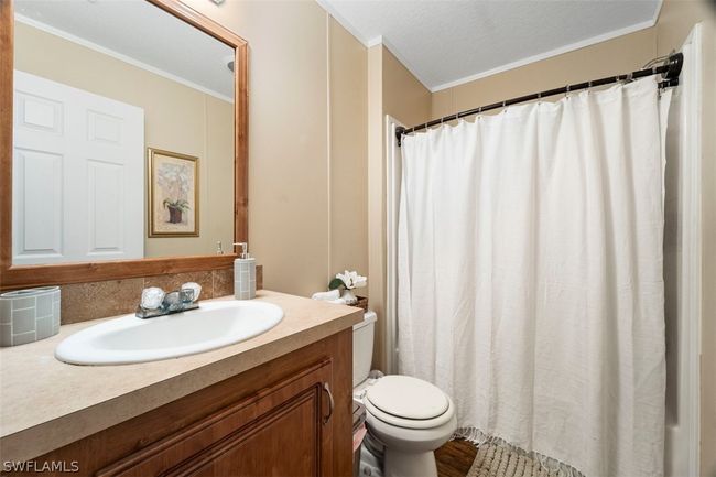 Bathroom with crown molding, hardwood / wood-style flooring, toilet, and vanity | Image 21