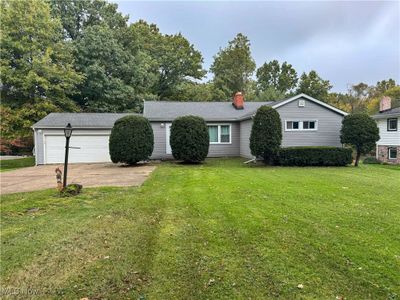 Single story home with a garage and a front lawn | Image 1