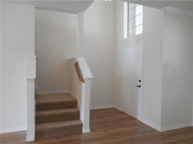 Stairs with wood finished floors and baseboards | Image 5