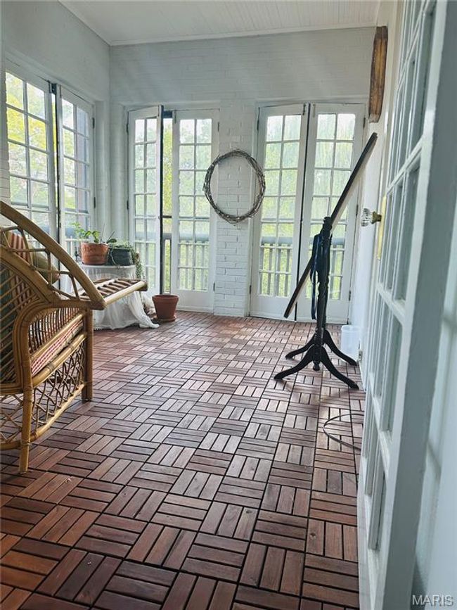 Unfurnished sunroom featuring brick floors | Image 10
