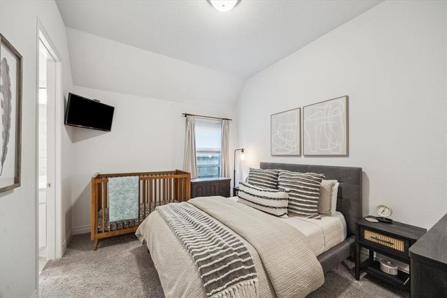 The second guest bedroom features plush carpeting, generous space, and a private en suite bathroom, combining comfort and convenience. | Image 23