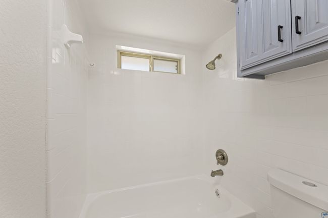 Bathroom with bathtub / shower combination and toilet | Image 23
