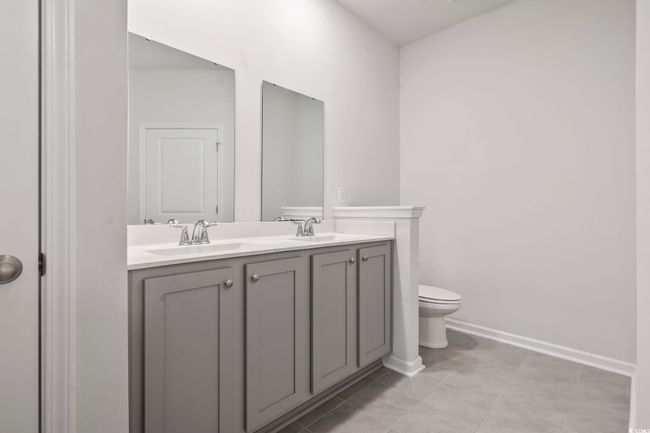 Bathroom with double vanity and tile patterned flooring | Image 19
