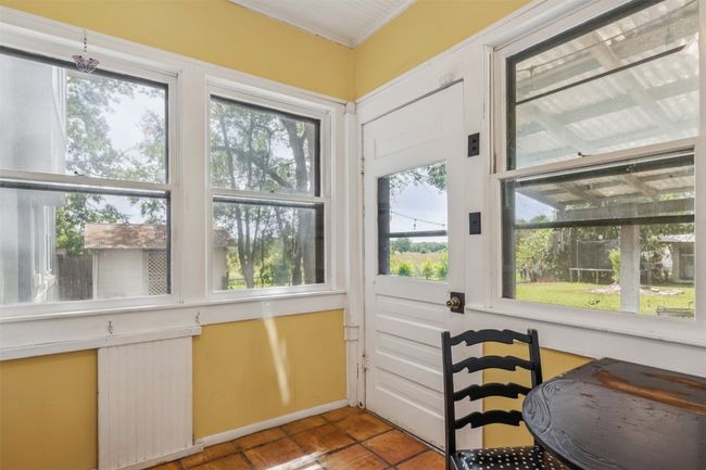 Sunroom / solarium with tile patterned floors and ornamental molding | Image 17