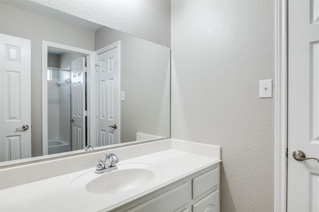 Full bath featuring a textured wall and vanity | Image 22