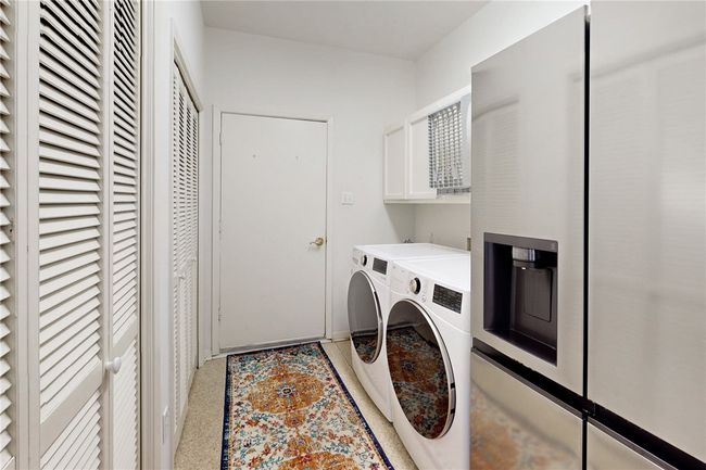 Washroom with washing machine and clothes dryer and cabinet space | Image 25
