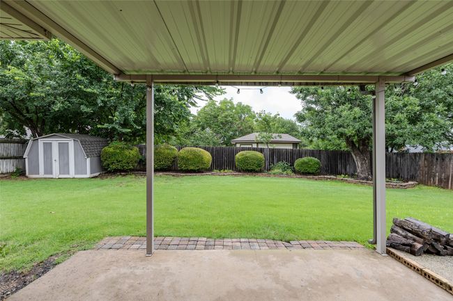Fenced backyard featuring a patio and a storage shed | Image 31