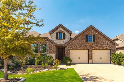 View of front facade featuring a front lawn and a garage | Image 3