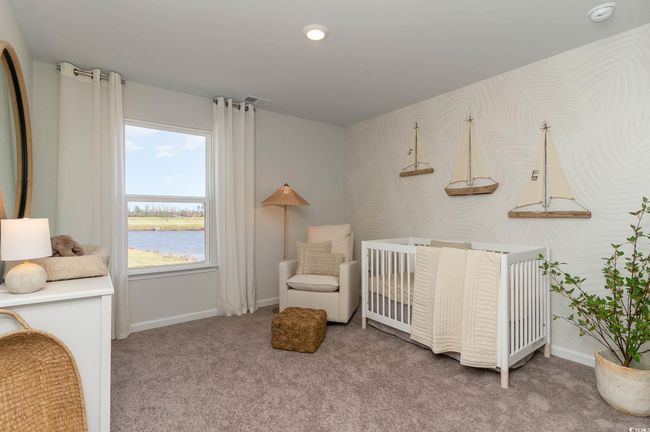 Bedroom featuring carpet floors, a water view, baseboards, and a crib | Image 21