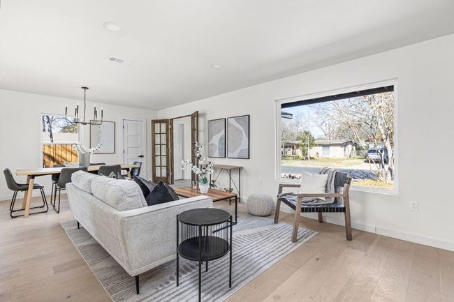 Living room featuring a chandelier, light wood finished floors, and recessed lighting | Image 6