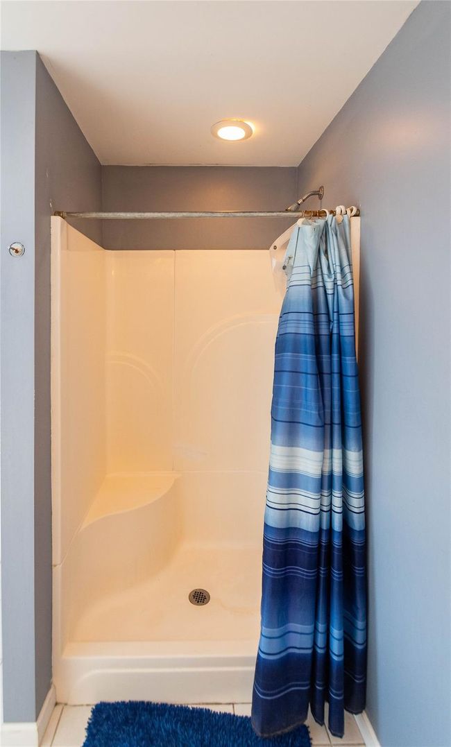 Bathroom with baseboards and a shower with curtain | Image 32