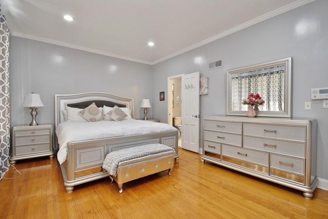 Primary Bedroom has hardwood floors, recessed lighting and crown molding | Image 17