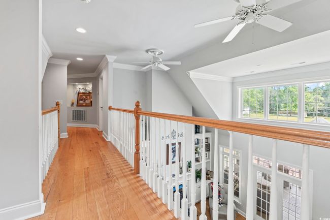Hallway with crown molding, recessed lighting, light wood-style floors, and baseboards | Image 16