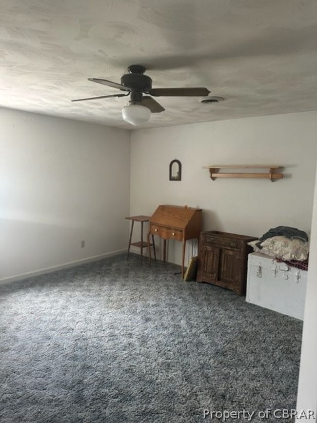 Carpeted empty room featuring ceiling fan | Image 16