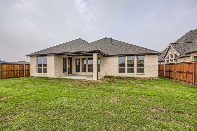 Rear view of house featuring a patio, brick siding, a fenced backyard, and a lawn | Image 28