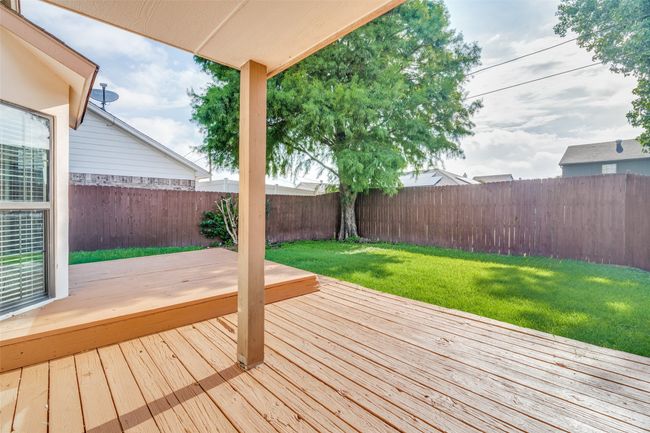 Wooden terrace with a fenced backyard | Image 24