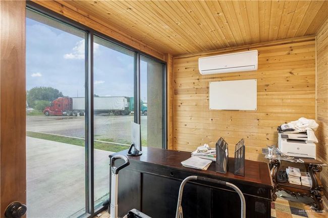 Office area featuring an AC wall unit, plenty of natural light, wood ceiling, and wooden walls | Image 21