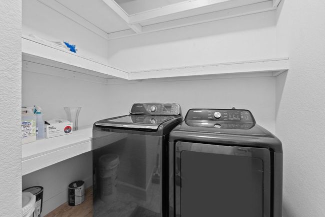 Laundry room featuring washing machine and clothes dryer and wood finished floors | Image 29