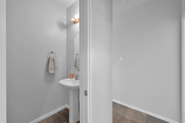 The downstairs powder bath, tucked away in the hallway to the laundry room. | Image 31