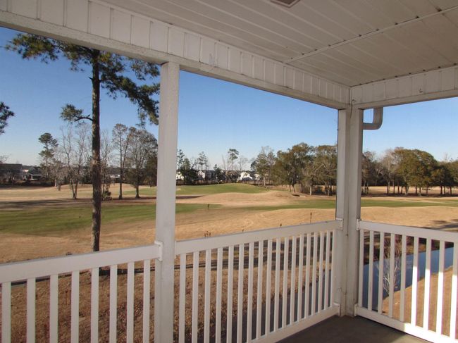 Screen porch with golf course view. | Image 34