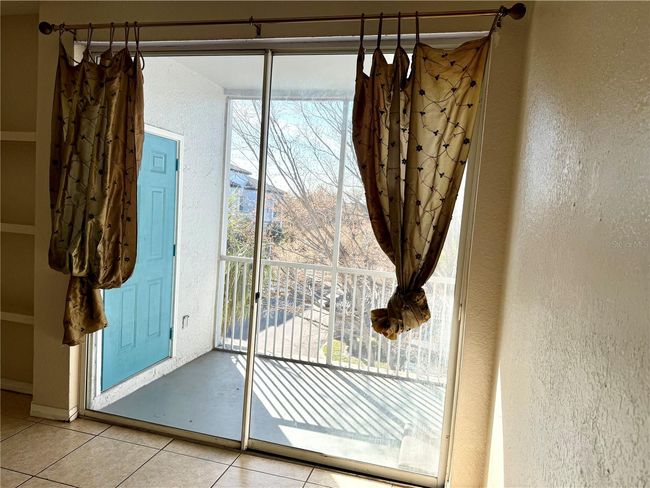 Screened Covered Balcony with Storage Room Out From Living Room through the Sliding Door | Image 8
